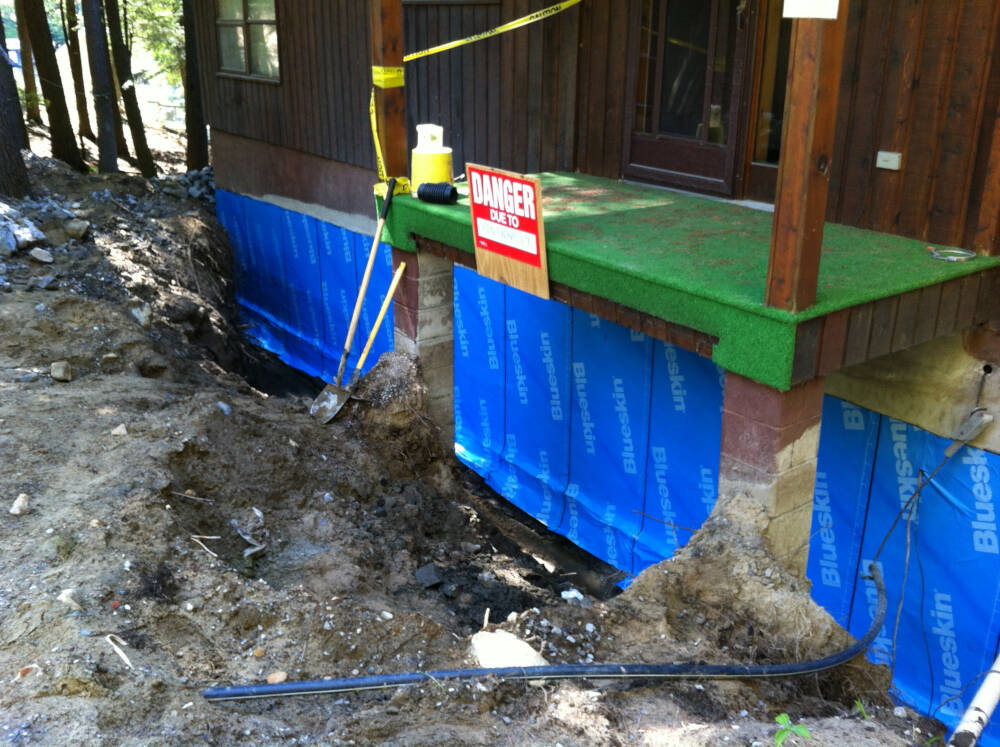 Henry Blueskin foundation waterproofing membrane installed on a foundation waterproofing and drainage retrofit project by this Muskoka custom builder.