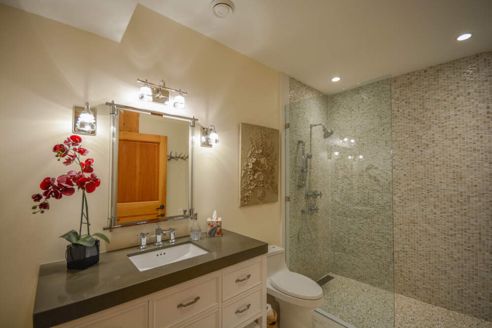 Interior of a luxury bathroom including glass-enclosed, tiled shower near Gravenhurst in Muskoka, Ontario.