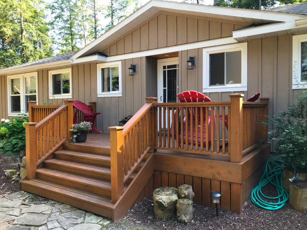 Cedar deck and entry door to a cottage renovation in Township of Lake of Bays, Muskoka, Ontario.
