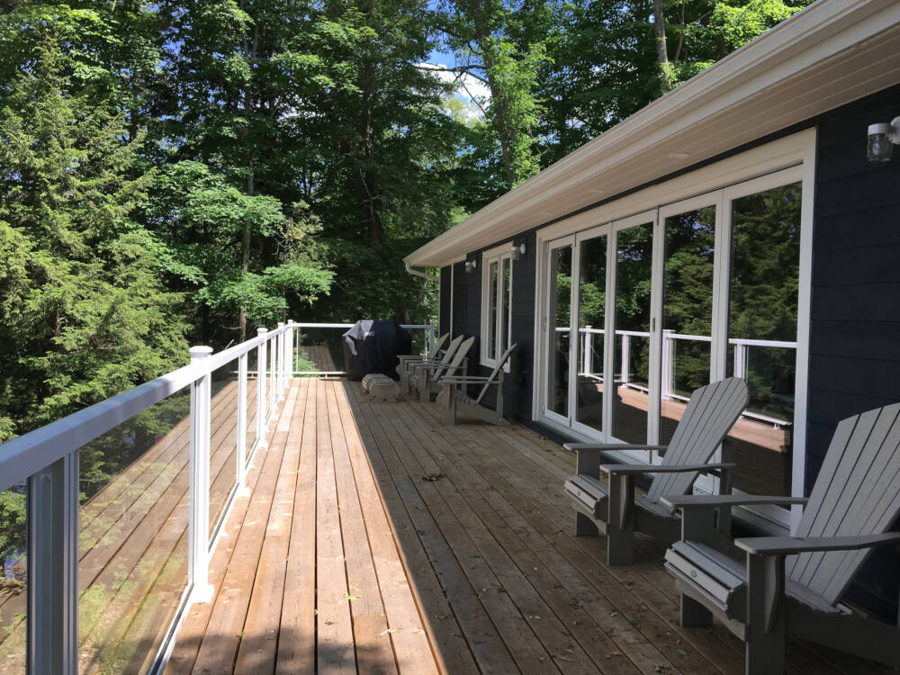 Sunny deck with large bi-folding doors connecting to the cottage interior on Lake Muskoka.