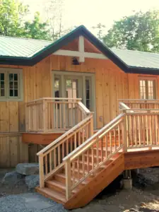 Wood siding and a cedar deck are traditional elements of the vernacular residential architecture of Muskoka, Ontario.