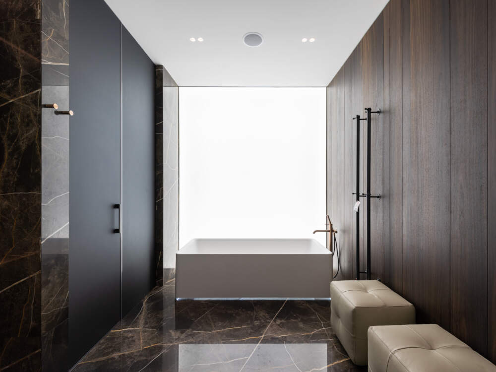Modern home design offering large picture window glass opening onto the waterfront for expansive panoramic landscape views.