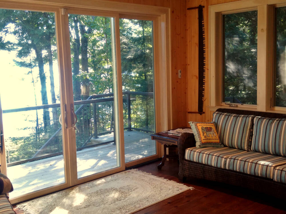 Wood flooring, wall and ceiling paneling in eastern white pine are traditional interior finishes for classic Muskoka cottage designs.
