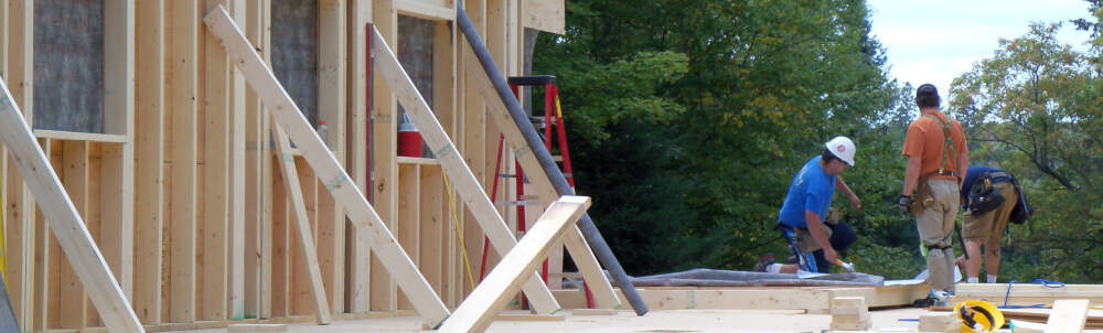 Carpentry staff and a wood frame home building project are pictured in the Township of Algonquin Highlands, Muskoka, Ontario.