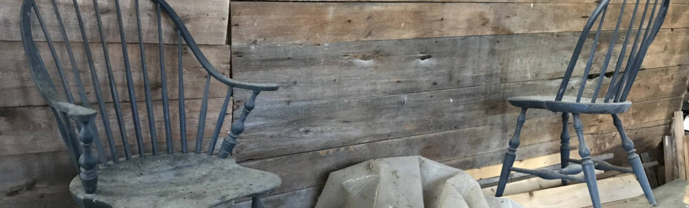 Handcrafted Windsor Chairs by Merv Hopkins collect dust and pigeon dirt in a timber-framed barn in Muskoka, Ontario.
